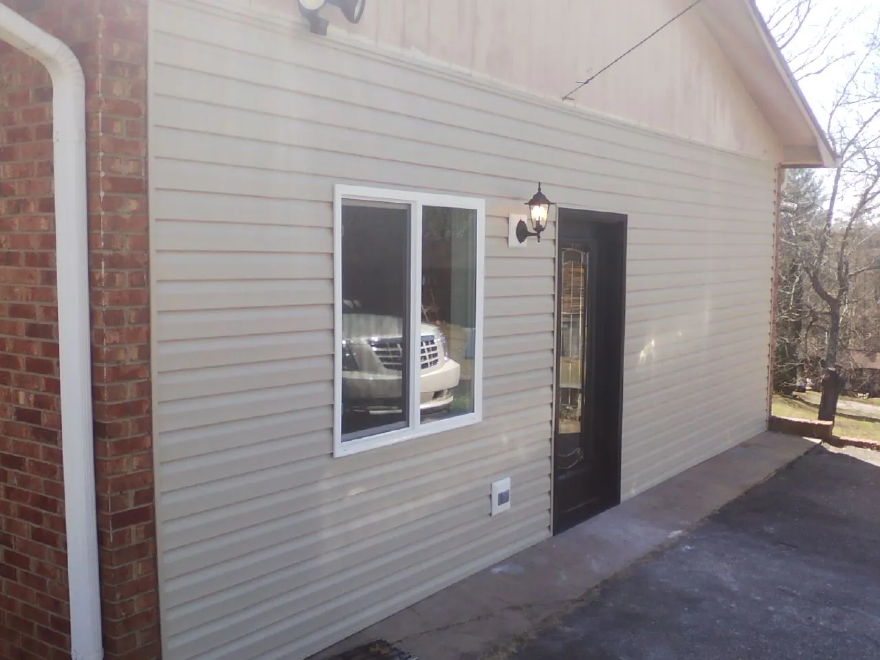 New vinyl siding and entry door on a room addition in Honea Path