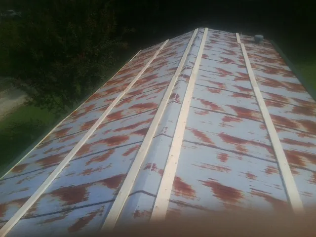 Rusted metal roof panels with new wood purlins before replacement — Storm Damage Roof Repair in Honea Path by Roofing Brothers